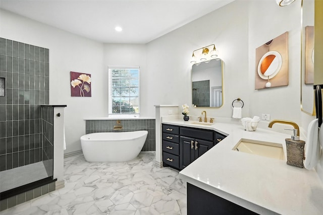 901 Bluebird Ct, Burleson, TX 76028 - bathroom featuring double vanity, a soaking tub, a walk in shower, marble finish flooring, and tile walls