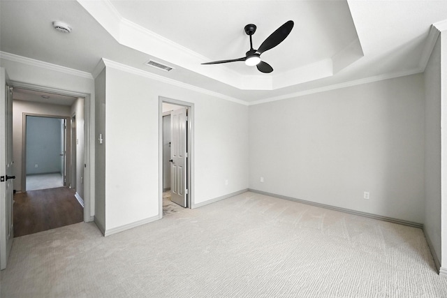 901 Bluebird Ct, Burleson, TX 76028 - unfurnished bedroom featuring a tray ceiling, light carpet, ornamental molding, and ceiling fan