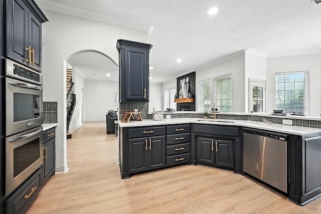 901 Bluebird Ct, Burleson, TX 76028 - kitchen featuring appliances with stainless steel finishes, crown molding, light countertops, healthy amount of natural light, and recessed lighting