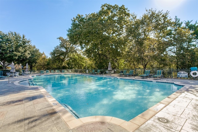 11937 Edgestone Rd, Dallas, TX 75230 - community pool featuring a patio area and view of scattered trees