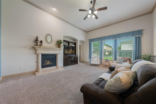 306 Spruce Trl, Forney, TX 75126 - living area with a glass covered fireplace, ornamental molding, ceiling fan, light carpet, and a towering ceiling