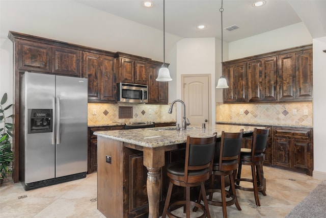 306 Spruce Trl, Forney, TX 75126 - kitchen with stainless steel appliances, light stone countertops, dark brown cabinetry, backsplash, and recessed lighting