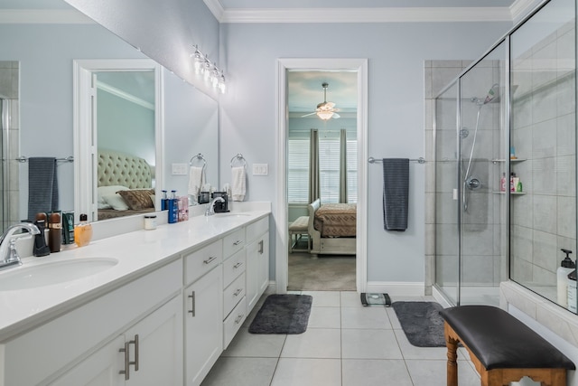 5616 Traveller Dr, North Richland Hills, TX 76180 - bathroom featuring connected bathroom, double vanity, a shower stall, tile patterned flooring, and crown molding