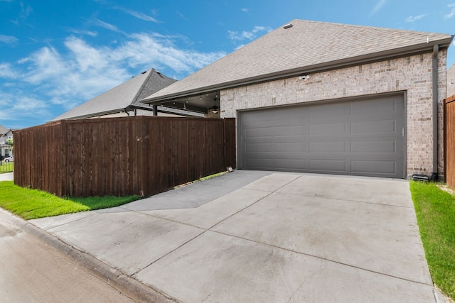 5616 Traveller Dr, North Richland Hills, TX 76180 - view of side of property featuring concrete driveway, a shingled roof, an attached garage, and brick siding