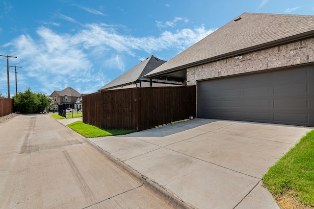 5616 Traveller Dr, North Richland Hills, TX 76180 - view of property exterior with driveway, a shingled roof, and a garage