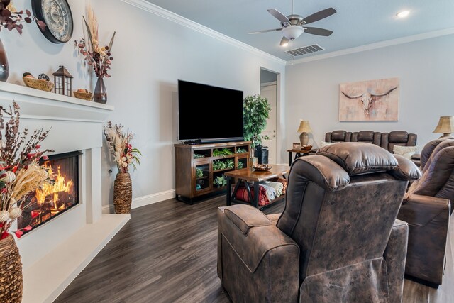 5616 Traveller Dr, North Richland Hills, TX 76180 - living room with dark wood-type flooring, ornamental molding, a lit fireplace, and a ceiling fan