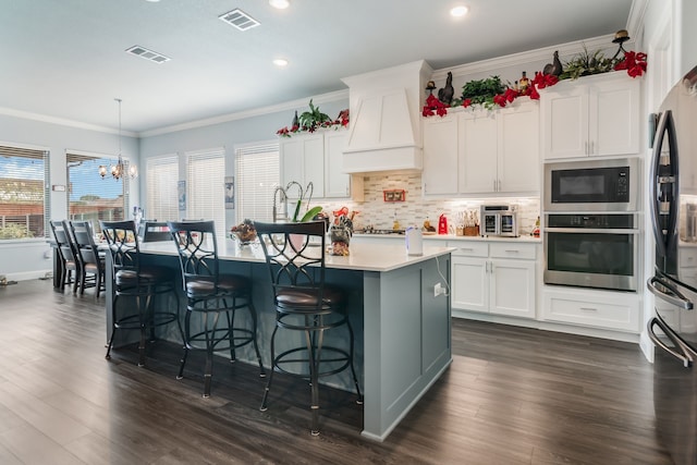 5616 Traveller Dr, North Richland Hills, TX 76180 - kitchen with stainless steel oven, built in microwave, custom exhaust hood, freestanding refrigerator, and ornamental molding