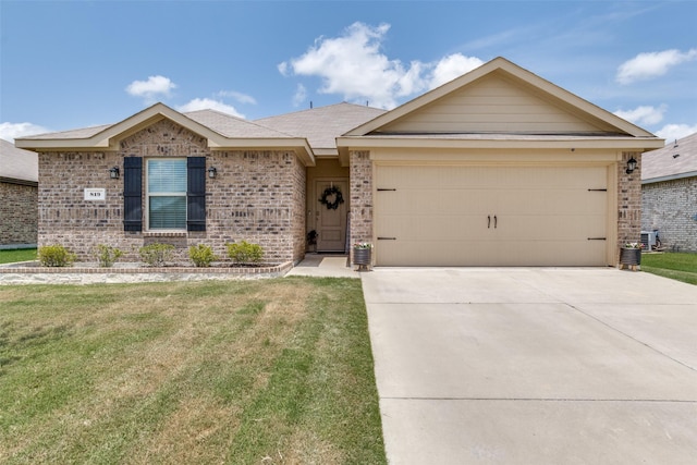 819 Twin Edge Dr, Royse City, TX 75189 - single story home featuring brick siding, driveway, a front lawn, and a garage