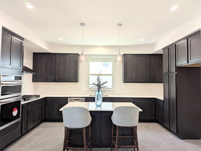 3763 Wenatche Dr, Dallas, TX 75233 - kitchen featuring stainless steel appliances, backsplash, light countertops, a kitchen island, and recessed lighting