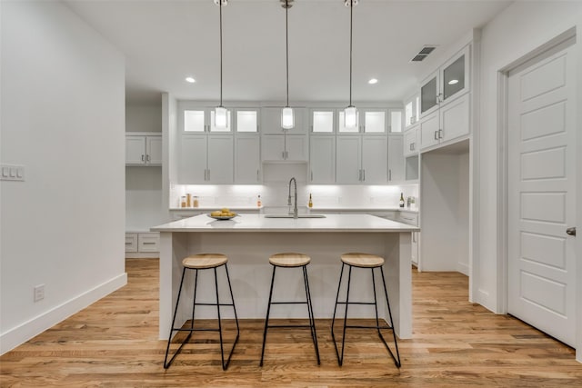 1403 Pueblo St, Dallas, TX 75212 - kitchen with recessed lighting, white cabinets, light countertops, and an island with sink