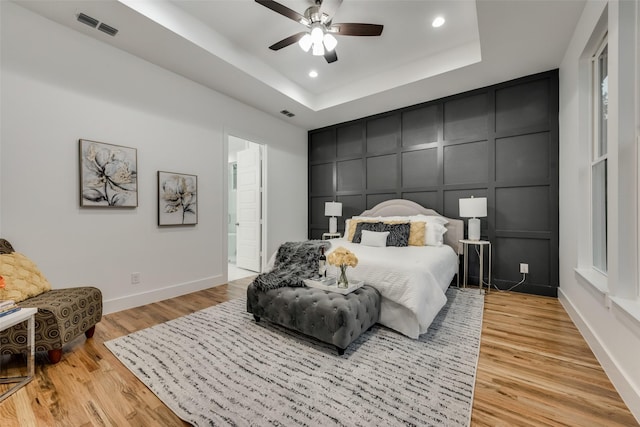 1403 Pueblo St, Dallas, TX 75212 - bedroom featuring a decorative wall, a tray ceiling, light wood finished floors, and recessed lighting