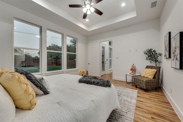 1403 Pueblo St, Dallas, TX 75212 - bedroom featuring light wood finished floors, recessed lighting, ceiling fan, and a tray ceiling