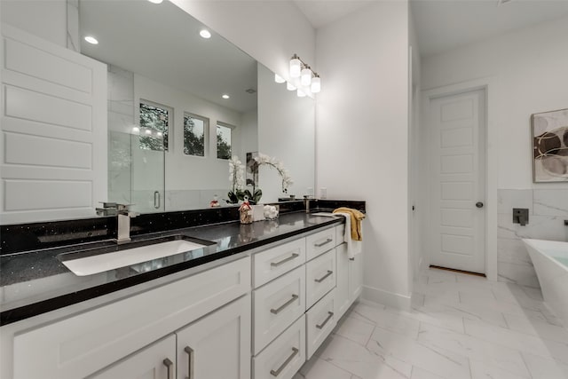 1403 Pueblo St, Dallas, TX 75212 - bathroom with double vanity, a soaking tub, marble look tiles, recessed lighting, and a stall shower