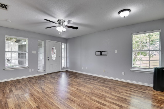 351 Marion Rd, Venus, TX 76084 - foyer entrance with wood finished floors, healthy amount of natural light, ceiling fan, and a textured ceiling