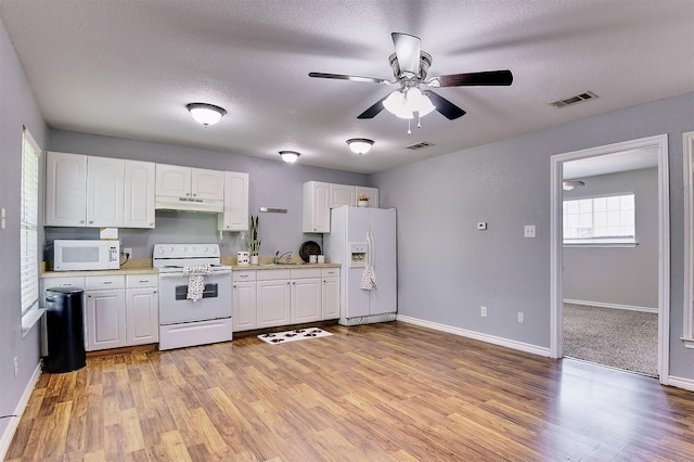 351 Marion Rd, Venus, TX 76084 - kitchen with white appliances, under cabinet range hood, light countertops, white cabinets, and ceiling fan