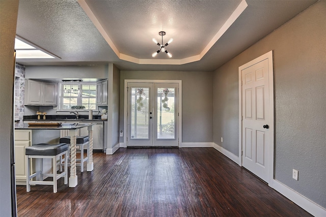 351 Marion Rd, Venus, TX 76084 - entryway with a chandelier, a tray ceiling, french doors, dark wood-type flooring, and a textured ceiling