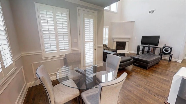 1320 Ponca St, Carrollton, TX 75010 - dining space featuring wood finished floors and a glass covered fireplace