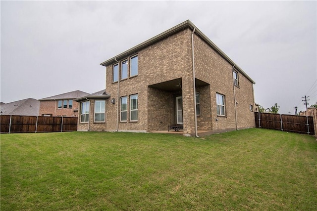 1320 Ponca St, Carrollton, TX 75010 - back of property featuring a fenced backyard, brick siding, and a patio