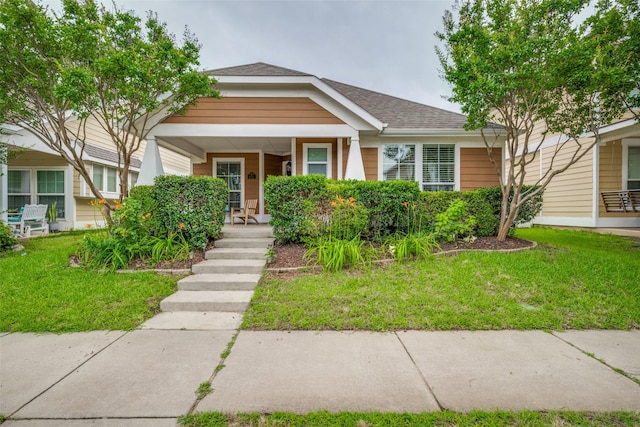 9032 Eagle Dr, Providence Village, TX 76227 - view of front facade featuring covered porch, a front lawn, and a shingled roof