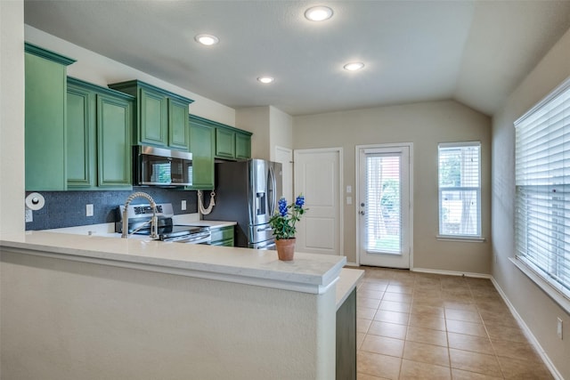 9032 Eagle Dr, Providence Village, TX 76227 - kitchen featuring green cabinetry, stainless steel appliances, light countertops, light tile patterned floors, and a peninsula