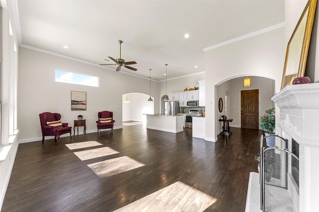 3014 Preston Club Dr, Sherman, TX 75092 - living room with arched walkways, a ceiling fan, a fireplace, dark wood-style flooring, and recessed lighting