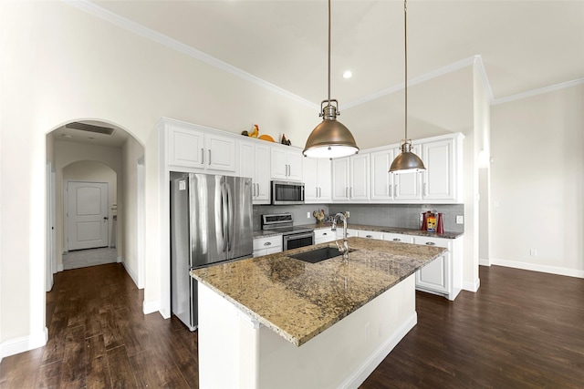 3014 Preston Club Dr, Sherman, TX 75092 - kitchen featuring stainless steel appliances, arched walkways, dark wood finished floors, light stone counters, and white cabinets
