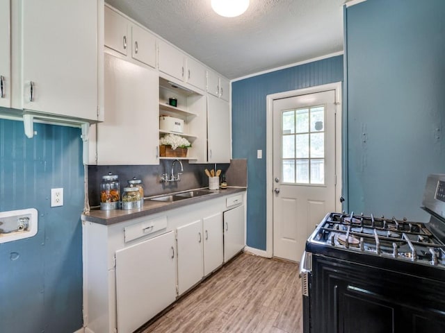 5316 Gordon Ave, Fort Worth, TX 76115 - kitchen featuring range with gas stovetop, open shelves, white cabinets, light wood-style flooring, and a textured ceiling