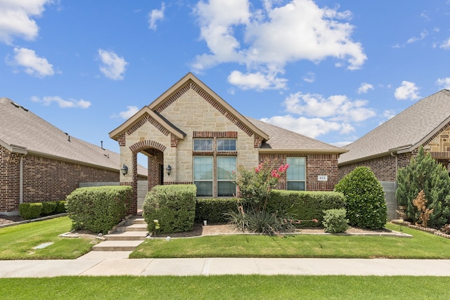 913 Parkside Dr, Argyle, TX 76226 - french country inspired facade featuring stone siding, brick siding, and a front yard