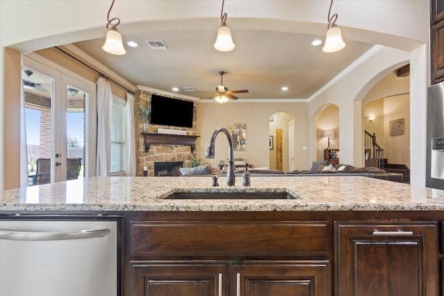 2213 Therese Dr, Waco, TX 76712 - kitchen featuring dishwasher, open floor plan, ceiling fan, dark brown cabinets, and ornamental molding