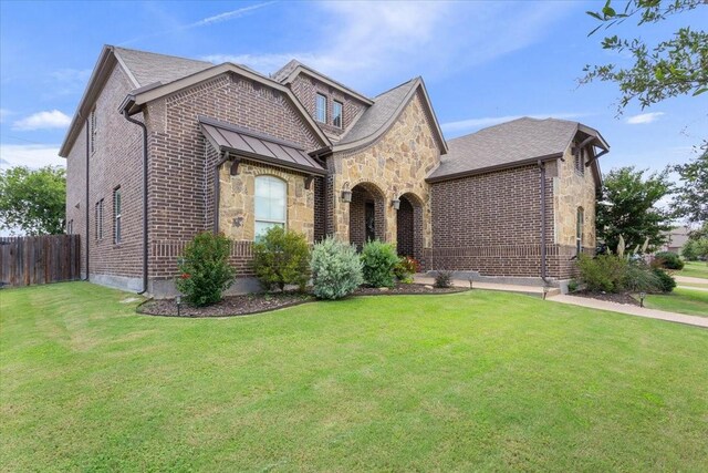 2213 Therese Dr, Waco, TX 76712 - view of front of property with stone siding, brick siding, and a standing seam roof