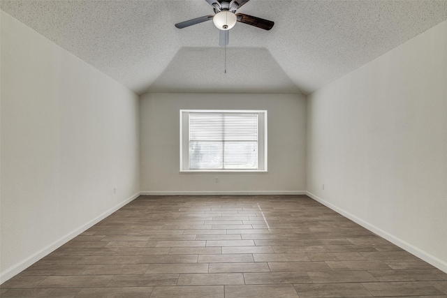 6414 Seaford Rd, Arlington, TX 76001 - additional living space with a textured ceiling, ceiling fan, dark wood-style flooring, and vaulted ceiling