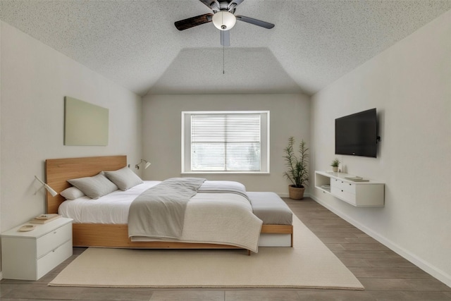 6414 Seaford Rd, Arlington, TX 76001 - bedroom with vaulted ceiling, wood finished floors, a textured ceiling, and ceiling fan