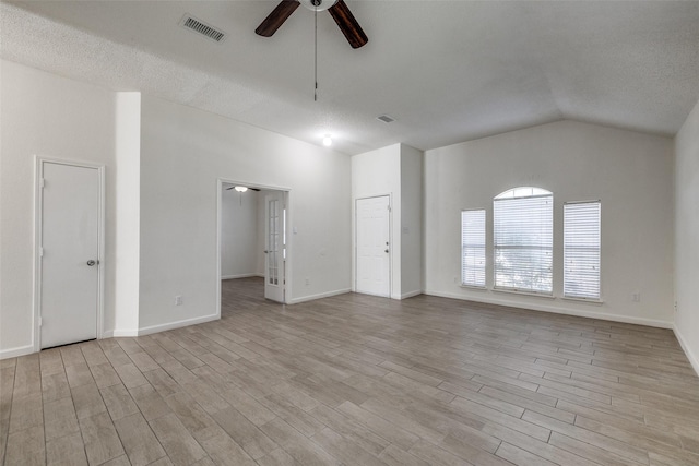 6414 Seaford Rd, Arlington, TX 76001 - unfurnished living room with ceiling fan, light wood-style flooring, vaulted ceiling, and a textured ceiling