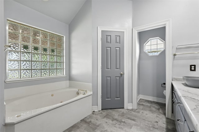 8301 Concord Dr, Rowlett, TX 75089 - bathroom featuring vanity and a tub with jets