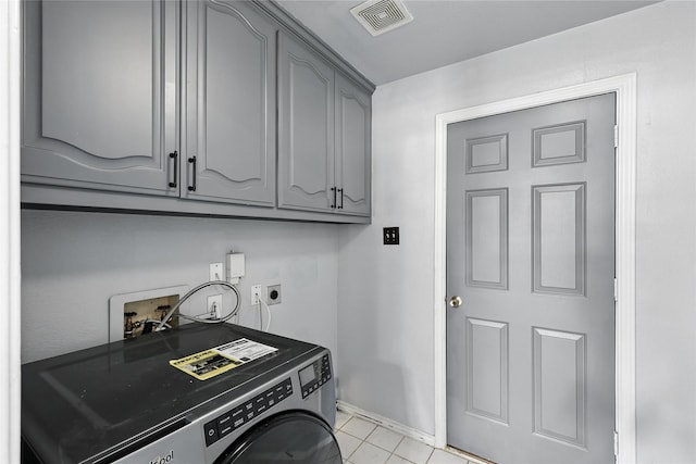 8301 Concord Dr, Rowlett, TX 75089 - laundry room with cabinet space, washer / dryer, and light tile patterned flooring