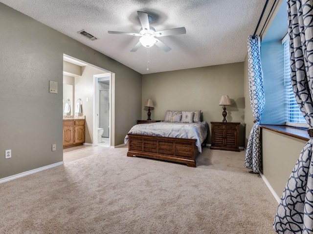 713 Bordner Dr, Lancaster, TX 75146 - carpeted bedroom with a textured ceiling, ensuite bathroom, and a ceiling fan