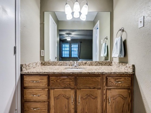 713 Bordner Dr, Lancaster, TX 75146 - ensuite bathroom featuring vanity, a textured wall, a chandelier, and a ceiling fan