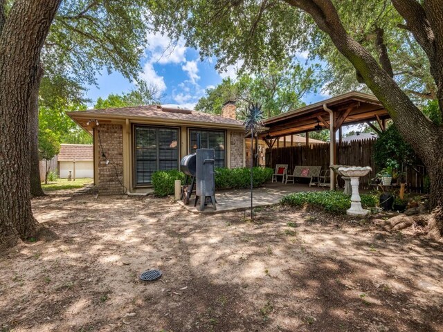 713 Bordner Dr, Lancaster, TX 75146 - rear view of house featuring a chimney and a patio area