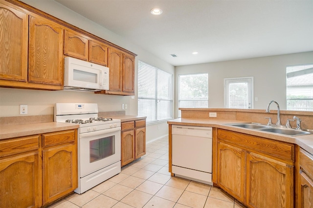 5831 Melanie Ct, Fort Worth, TX 76131 - kitchen featuring white appliances, light tile patterned floors, brown cabinetry, light countertops, and recessed lighting