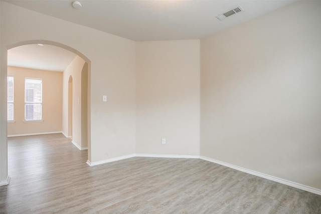 5831 Melanie Ct, Fort Worth, TX 76131 - unfurnished room with wood finished floors, arched walkways, and a smoke detector