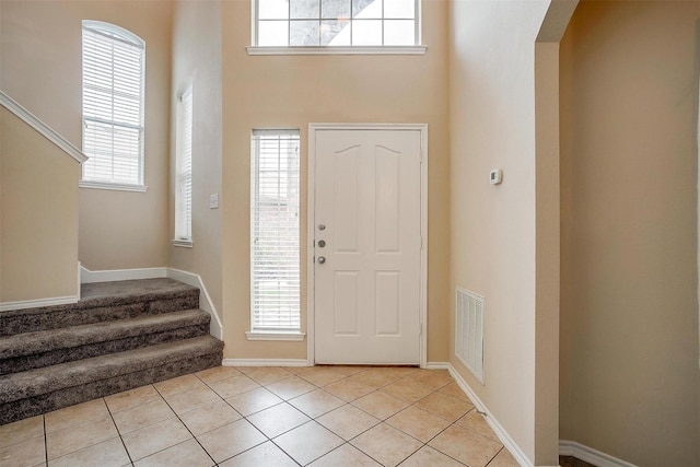 5831 Melanie Ct, Fort Worth, TX 76131 - entryway with a towering ceiling, healthy amount of natural light, arched walkways, stairway, and light tile patterned floors