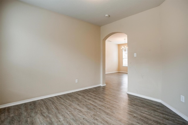 5831 Melanie Ct, Fort Worth, TX 76131 - spare room with arched walkways, dark wood finished floors, and a chandelier