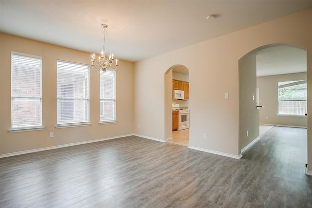 5831 Melanie Ct, Fort Worth, TX 76131 - spare room with light wood-style flooring, a chandelier, and arched walkways