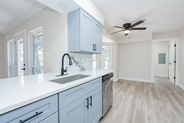 3733 Magnolia Dr, Grand Prairie, TX 75052 - kitchen with stainless steel dishwasher, healthy amount of natural light, light countertops, and light wood-style flooring