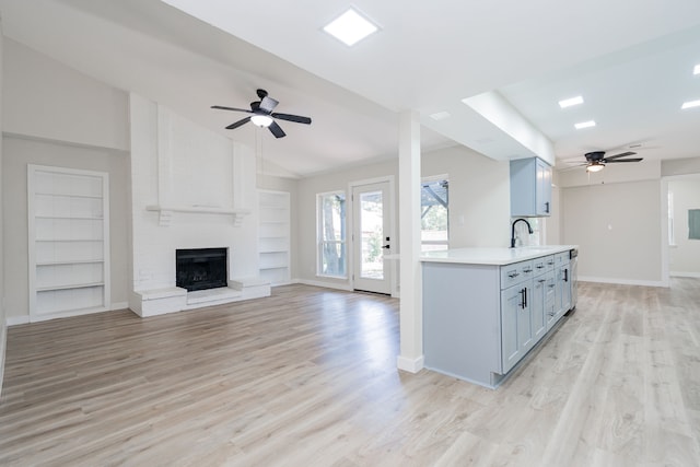 3733 Magnolia Dr, Grand Prairie, TX 75052 - unfurnished living room with ceiling fan, a fireplace, light wood finished floors, built in features, and vaulted ceiling