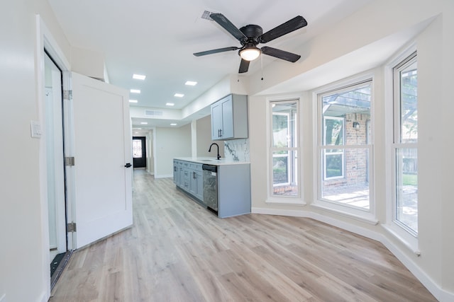 3733 Magnolia Dr, Grand Prairie, TX 75052 - kitchen featuring stainless steel dishwasher, light wood finished floors, light countertops, and plenty of natural light