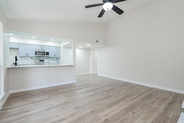 3733 Magnolia Dr, Grand Prairie, TX 75052 - unfurnished living room featuring a ceiling fan, light wood-type flooring, and high vaulted ceiling
