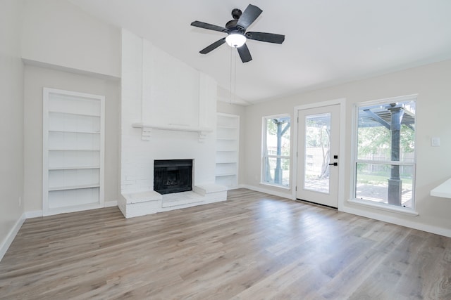 3733 Magnolia Dr, Grand Prairie, TX 75052 - unfurnished living room featuring built in shelves, light wood finished floors, a brick fireplace, ceiling fan, and high vaulted ceiling