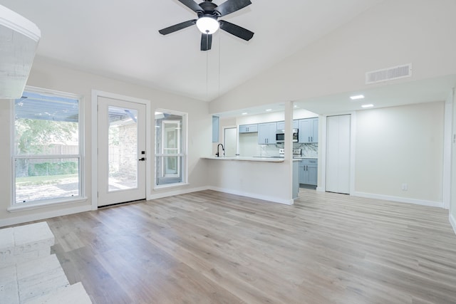 3733 Magnolia Dr, Grand Prairie, TX 75052 - unfurnished living room featuring vaulted ceiling, light wood finished floors, and ceiling fan