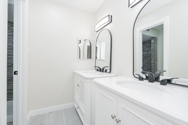 3733 Magnolia Dr, Grand Prairie, TX 75052 - bathroom featuring two vanities and baseboards